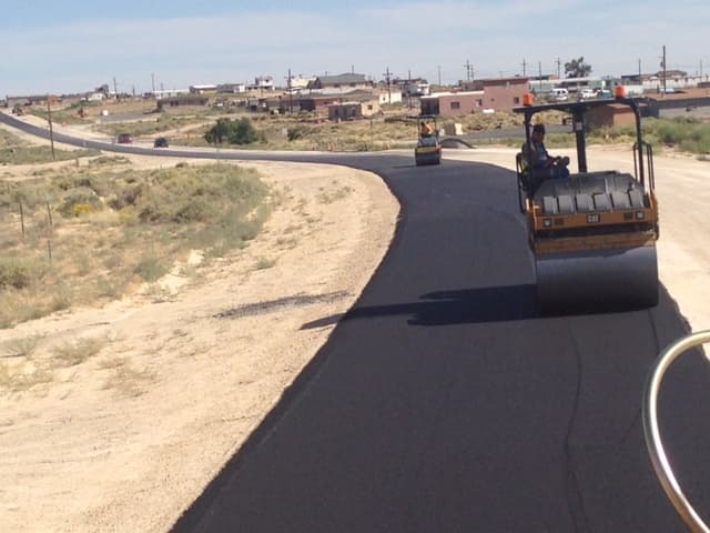 Roadway compaction with rollers ahead of paving