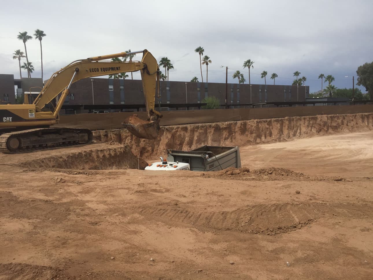 Excavator preparing a basin site for construction