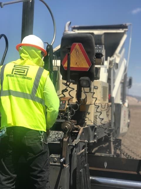 Shane’s Grading and Paving crew member operating a milling machine